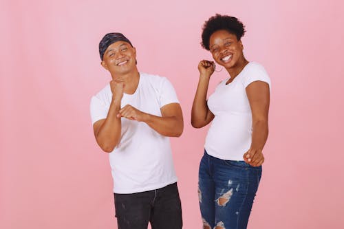 Man and Woman Dancing Together While Smiling at Camera