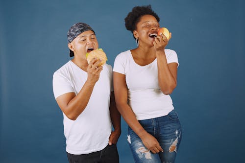 Free Man and Woman With Open Mouth While Holding Food Stock Photo