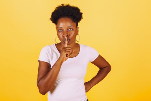 Free Woman in White Shirt Doing Keep Quiet Sign Stock Photo
