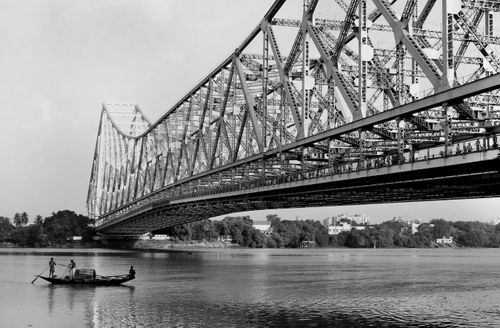 Free Black and white image of Howrah Bridge spanning the Hooghly River in Kolkata, India. Stock Photo