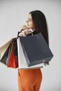 Woman in Brown Long Sleeve Shirt Holding Black Leather Handbag