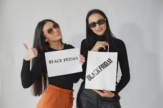 Two stylish women holding Black Friday shopping bags and signs, ready for sales.