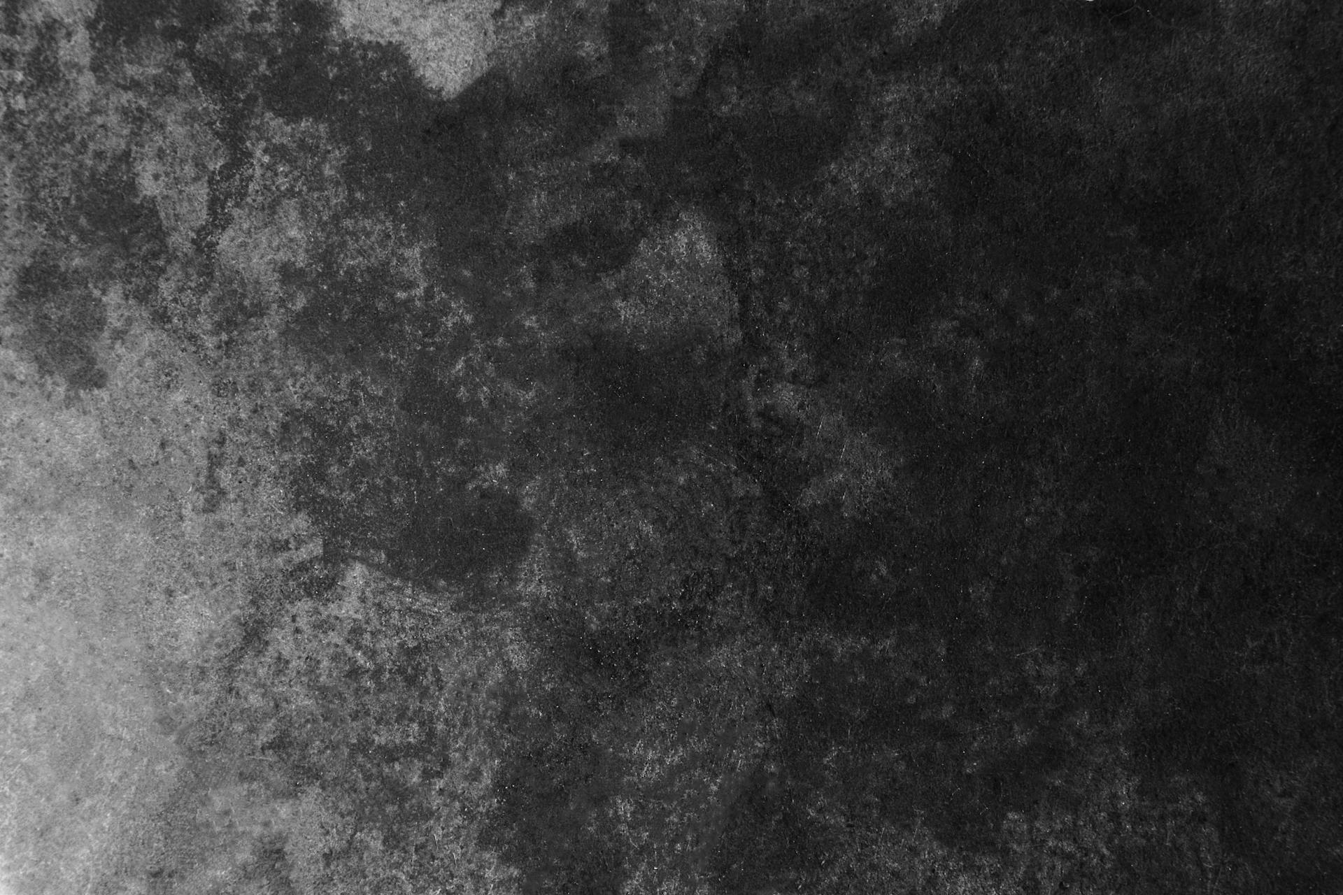 High-resolution dark grunge concrete texture for backgrounds and design projects.