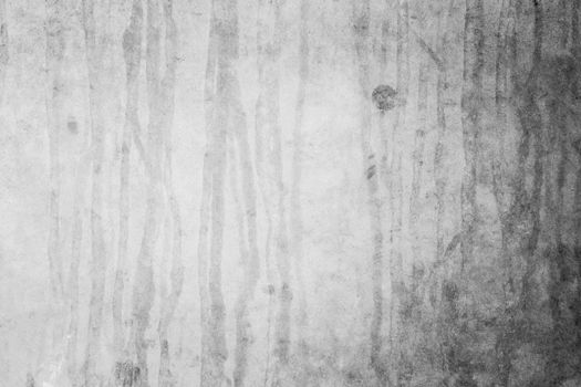A weathered concrete wall with a textured, abstract pattern ideal for backgrounds.