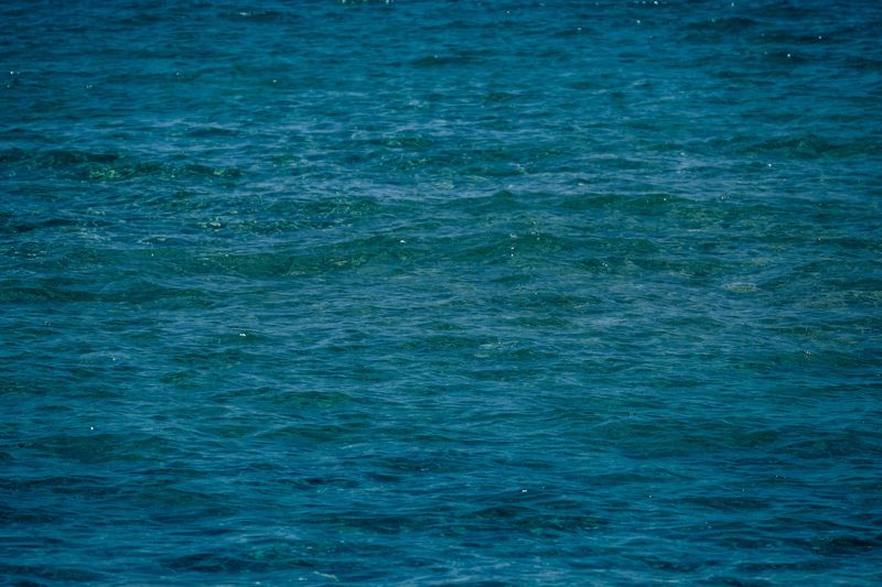 Wavy blue sea surface seen from above on a sunny day, photo by Francesco Ungaro on Pexels