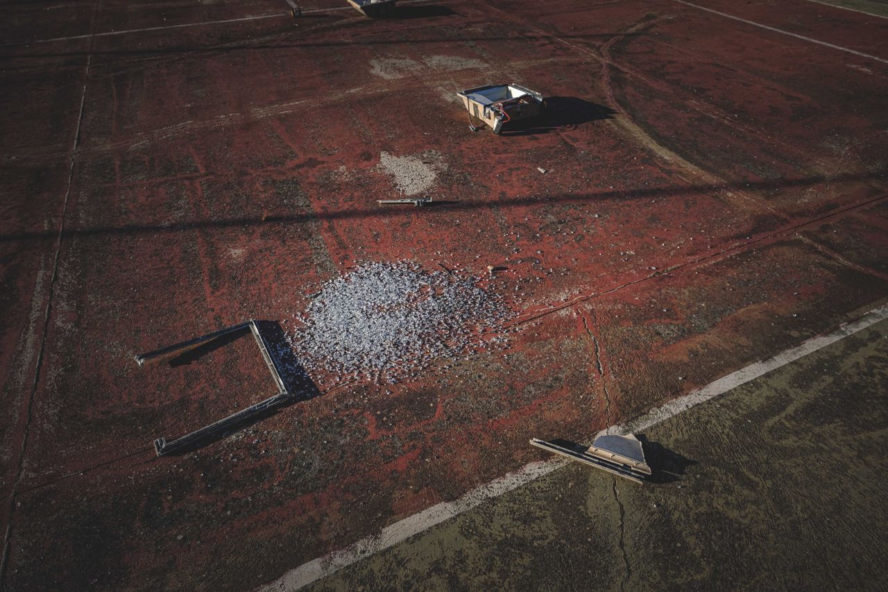 from above of details of broken outdoor lamp on shabby old sports grou
