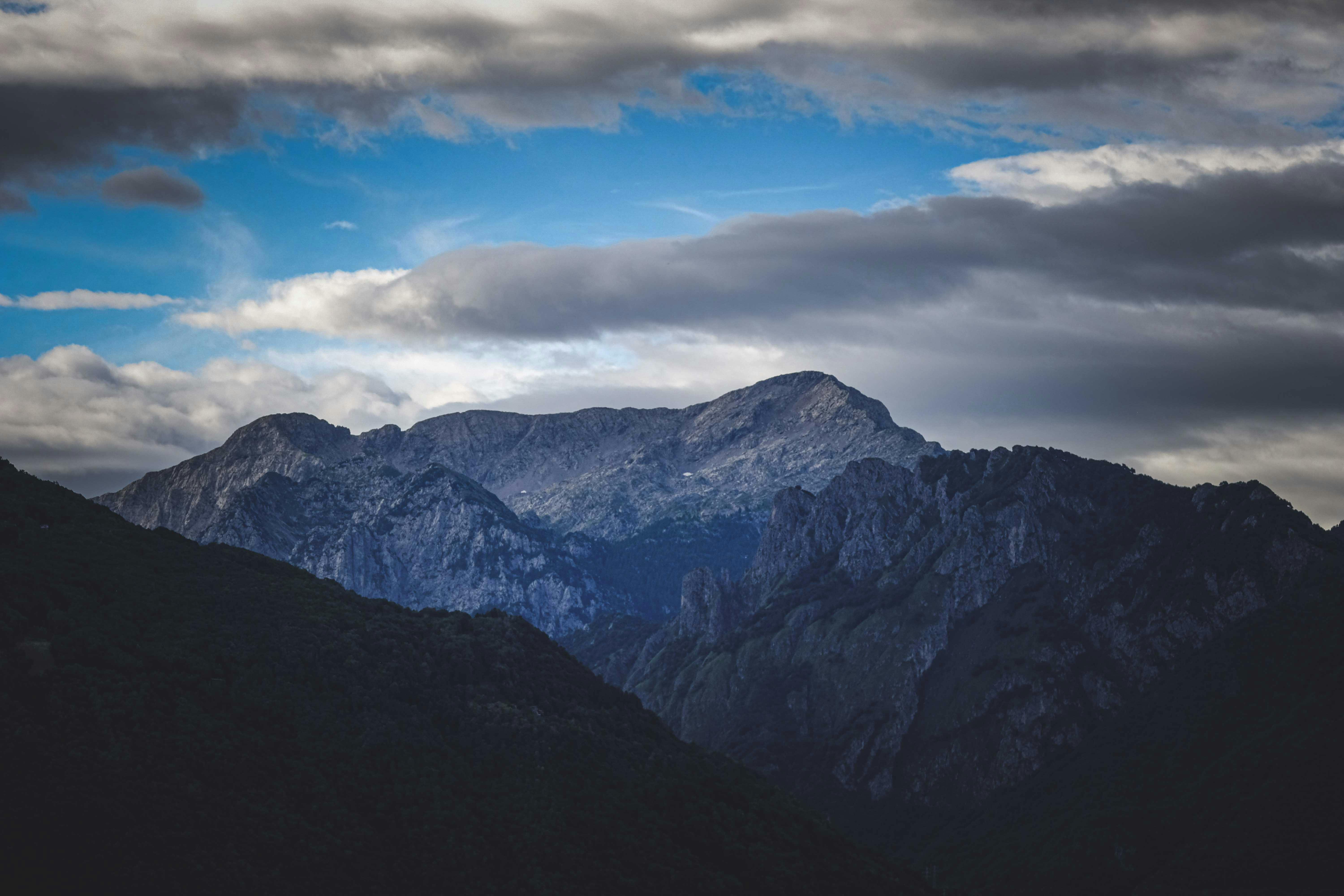 Cloudy sky over picturesque mountains in valley · Free Stock Photo