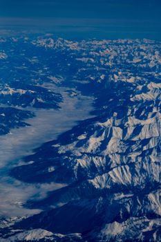 From above of picturesque scenery of snowy formations located on frozen terrain in winter time in nature in cold weather