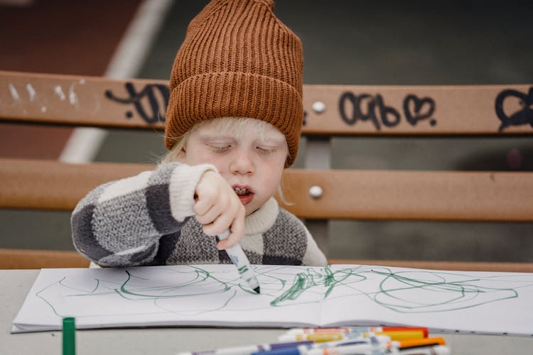 Cute Little Boy Drawing On Paper