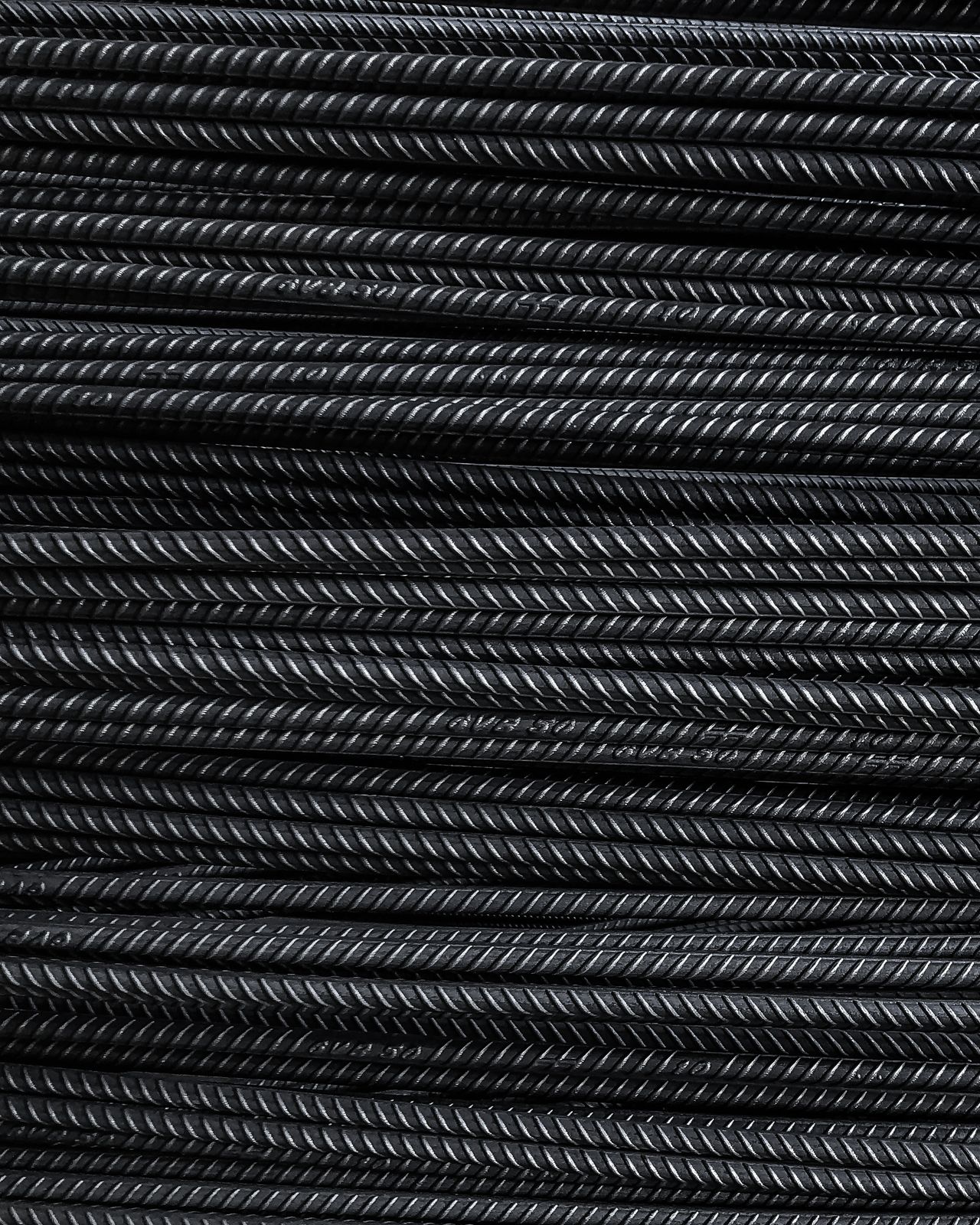 Close-up view of neatly stacked metal rebars showcasing detailed texture and industrial feel