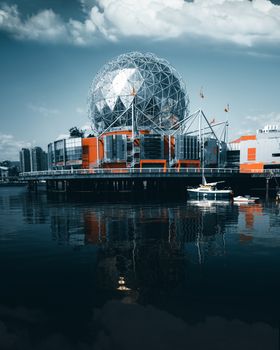 A captivating night view of Vancouver's iconic Science World with its modern geodesic dome reflecting on the water.
