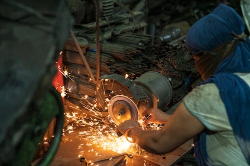 Person Grinding a Metal