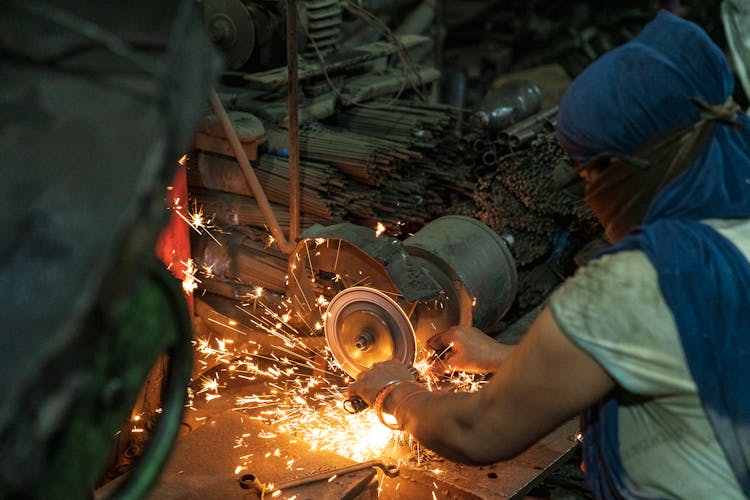 Person Grinding A Metal