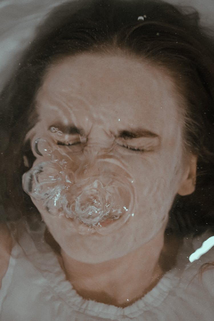 Woman Underwater In Bathtub With Bubbles