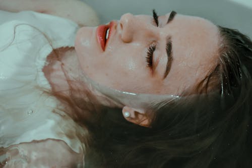 Free Woman resting in bathtub with eyes closed Stock Photo