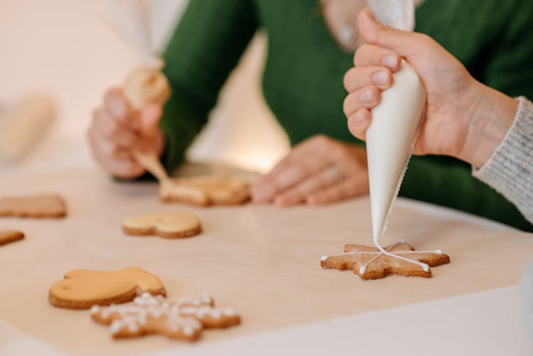 Two Girls Decorating Cookies With Icing