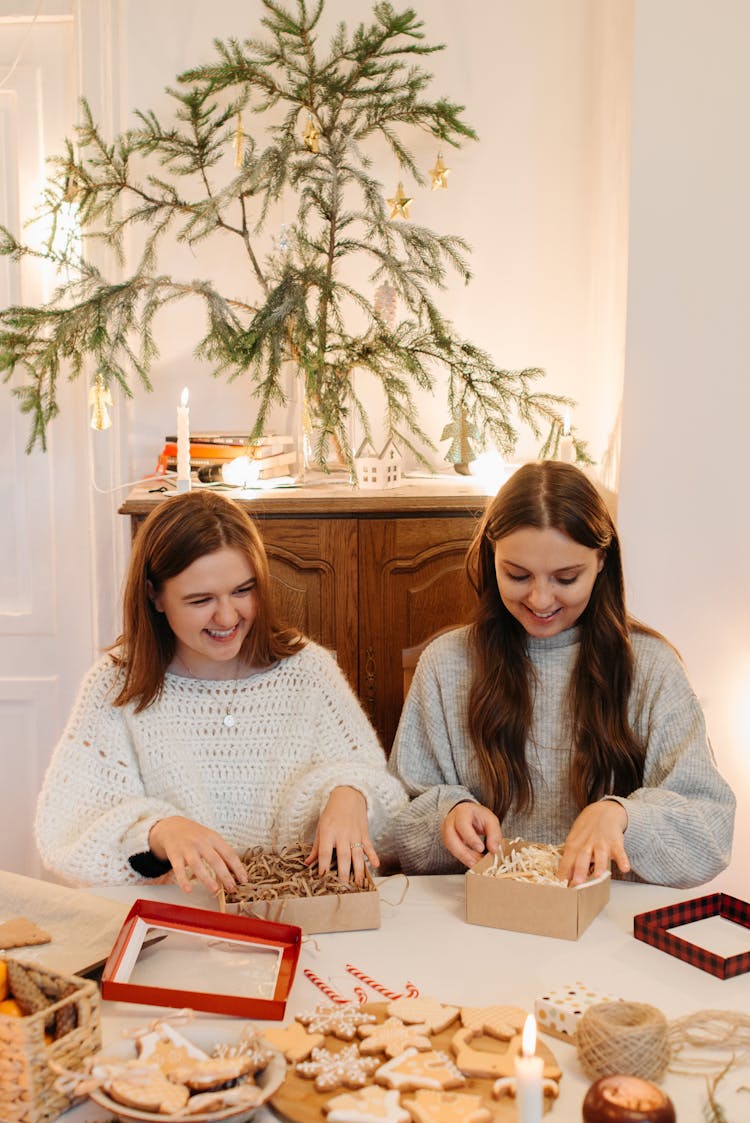 Young Girls Boxing Cookies For Holidays