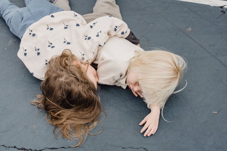 Little Siblings Hugging On Playground