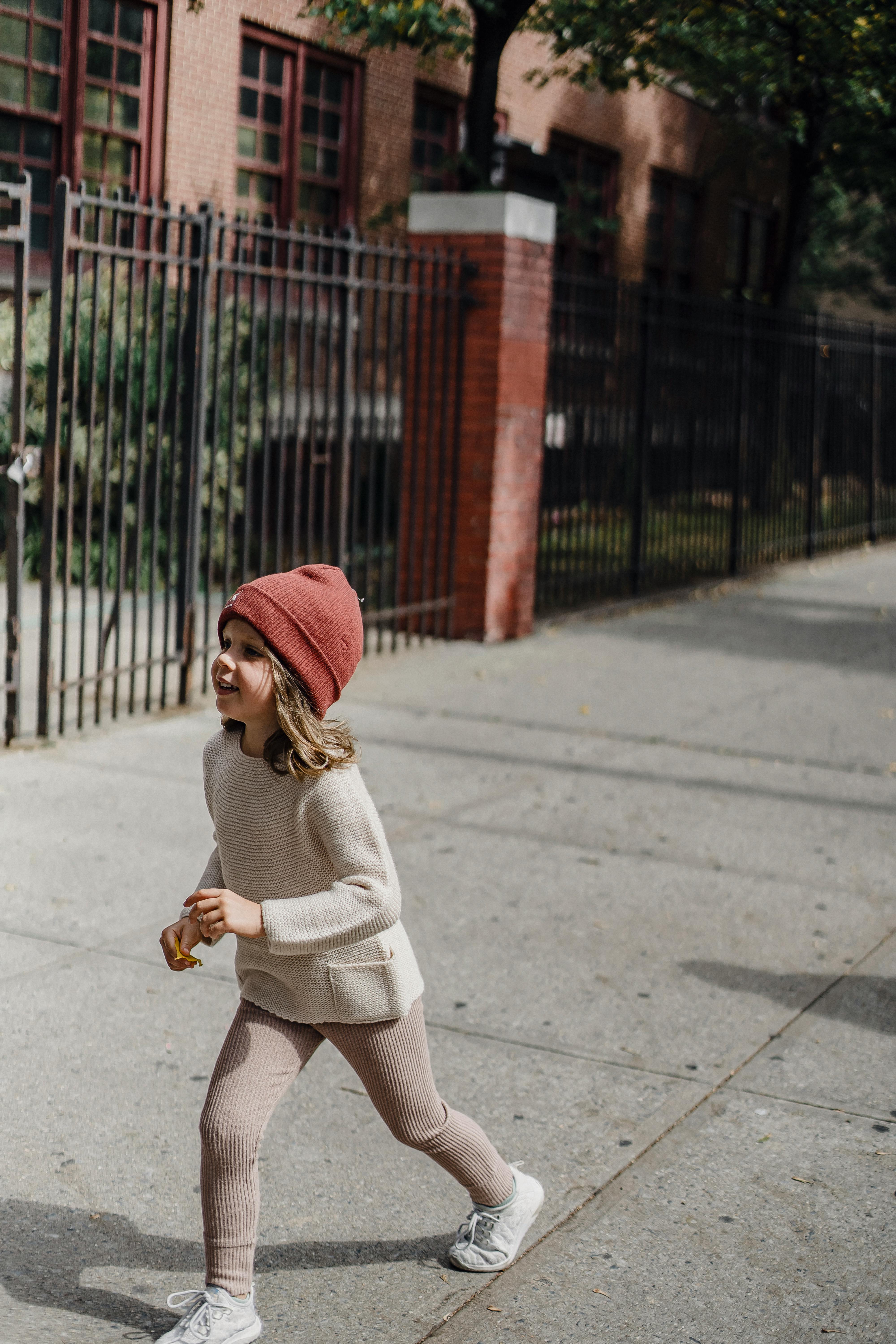 stylish girl walking on sidewalk