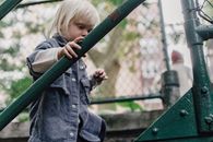 Crop little boy walking up stairs