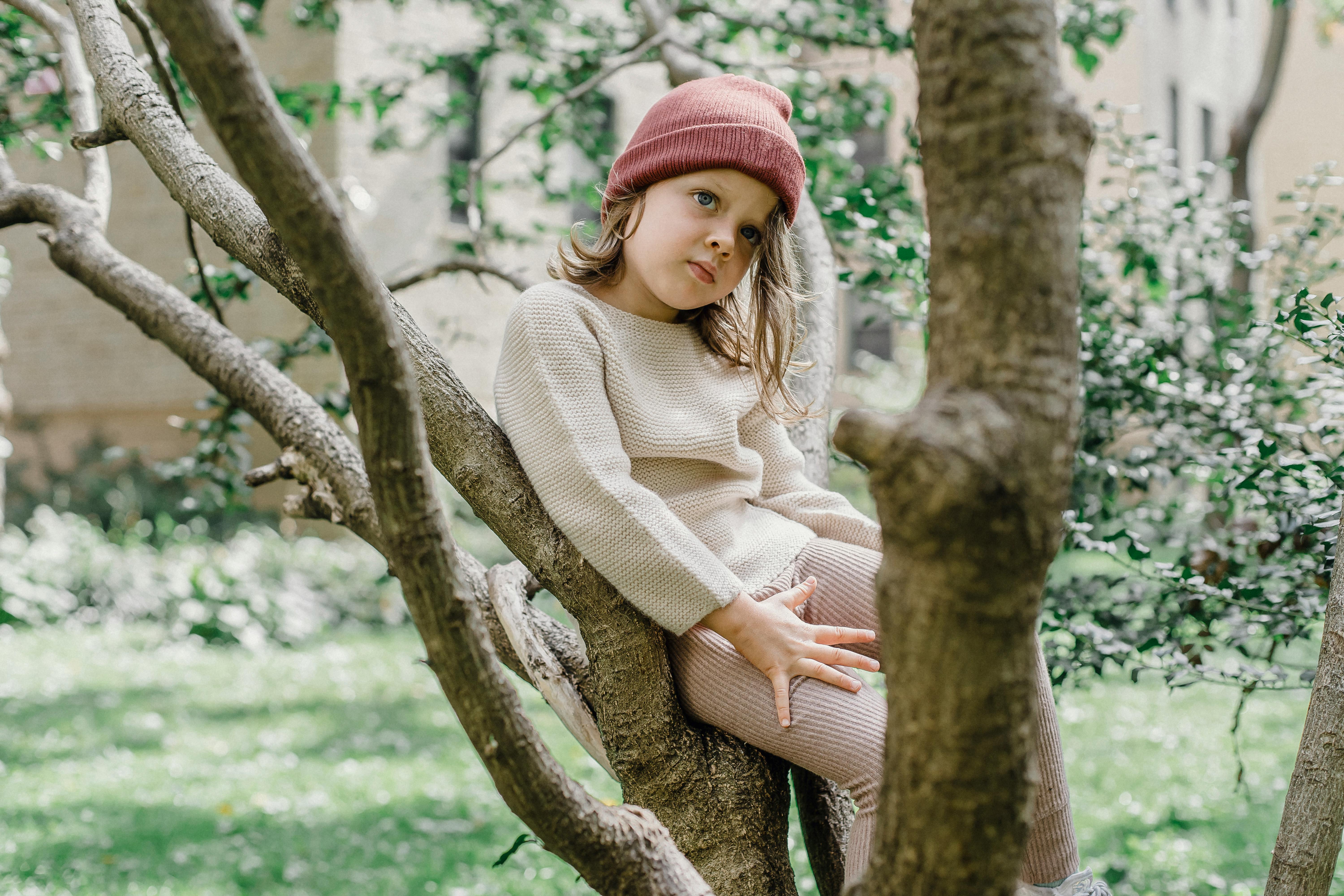 calm girl sitting on tree