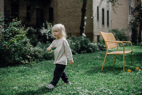 Little child playing in garden