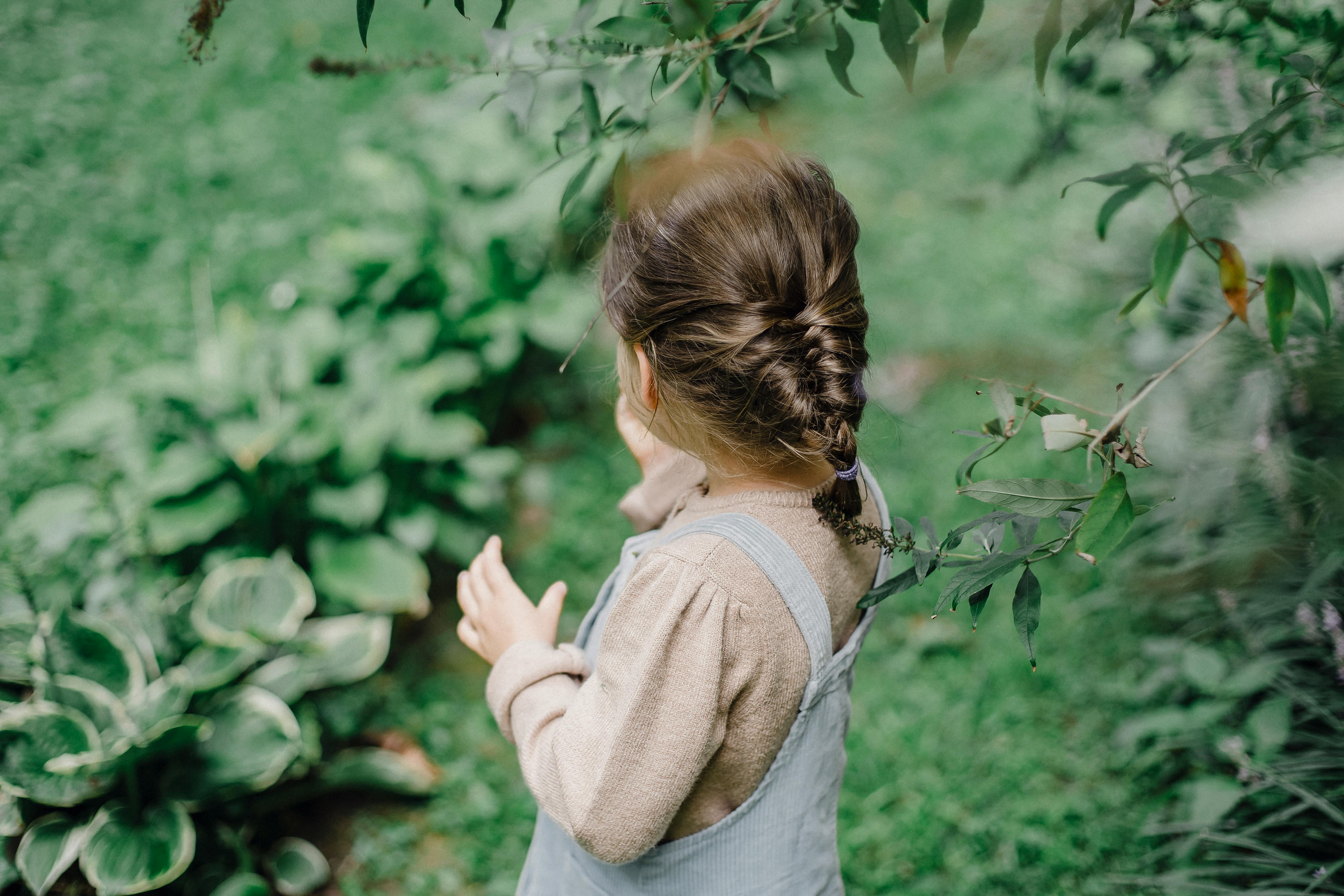 Girl Looking At A Green Garden · Free Stock Photo