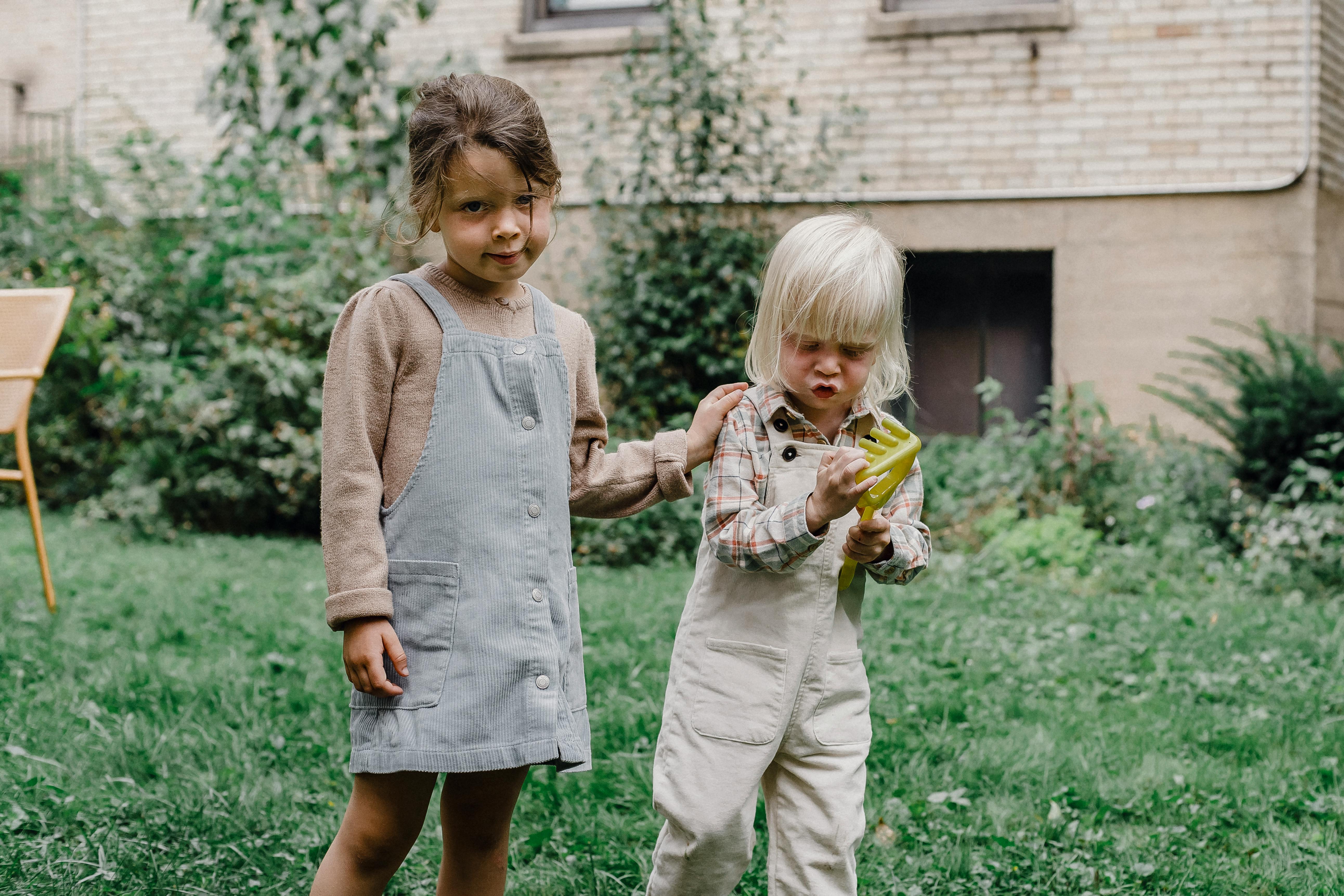 funny cute innocent children playing in yard