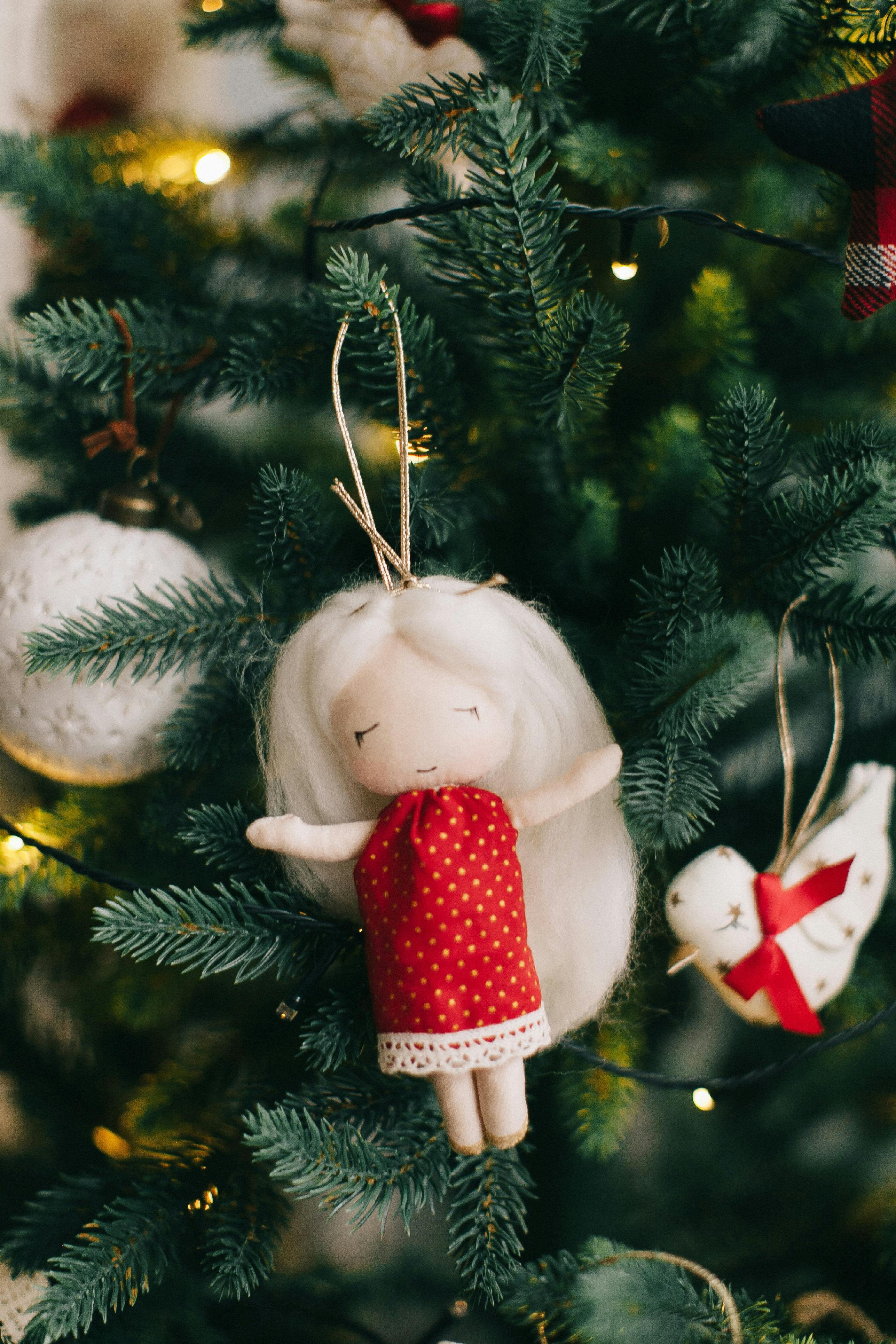 christmas tree decoration with a doll in a red dress