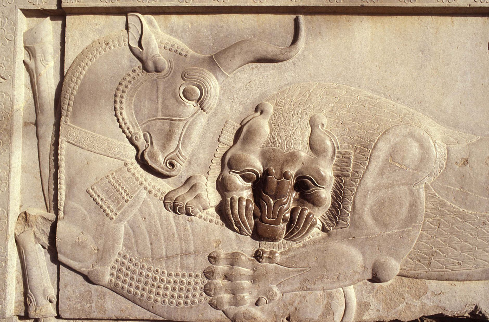 Detail of an ancient stone relief showcasing mythical creatures from Assyrian art.