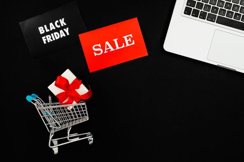 Free Top view of Black Friday sale with red gift box and laptop on black background. Stock Photo