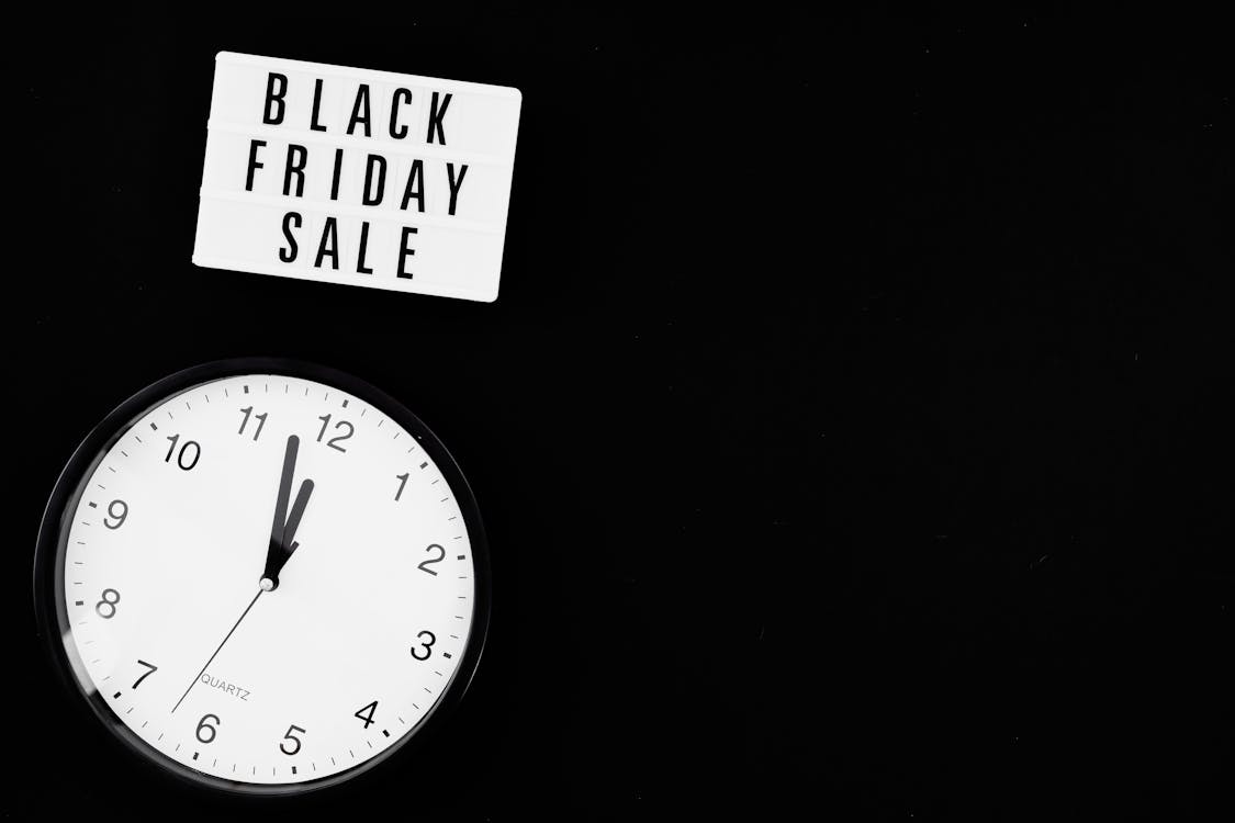 Free Black and White Analog Wall Clock Showing Time Of Black Friday Sale Stock Photo