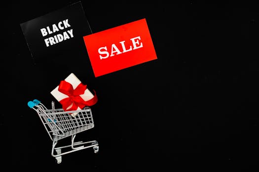 Shopping cart with gift box and Black Friday Sale signs on black background. Perfect for holiday promotions.