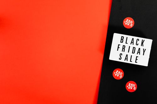 Free Black Friday sale advertisement with bold red background and discount signs. Stock Photo