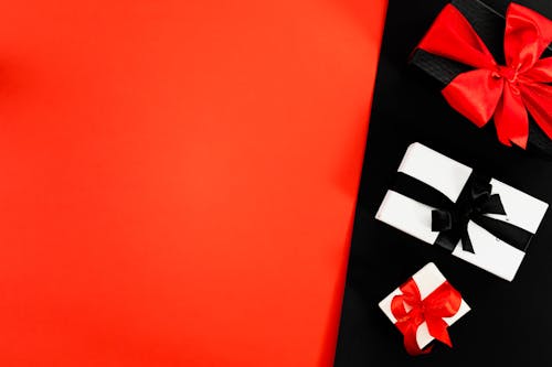  Three Boxes Tied With Ribbons on Red and Black Background