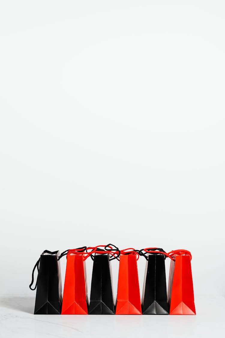 Black And Red Paper Bags On White Background