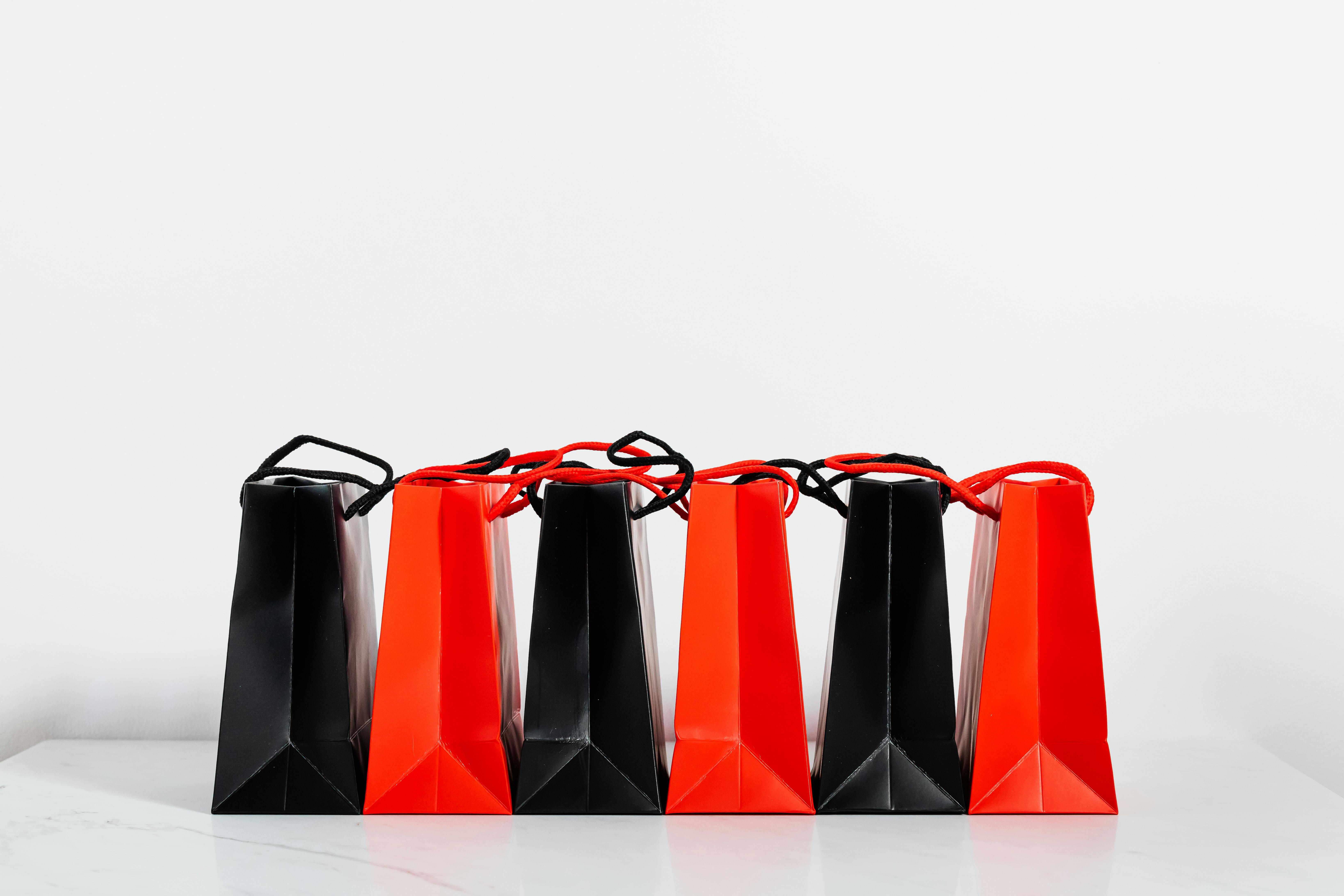 black and red paper bags on white background