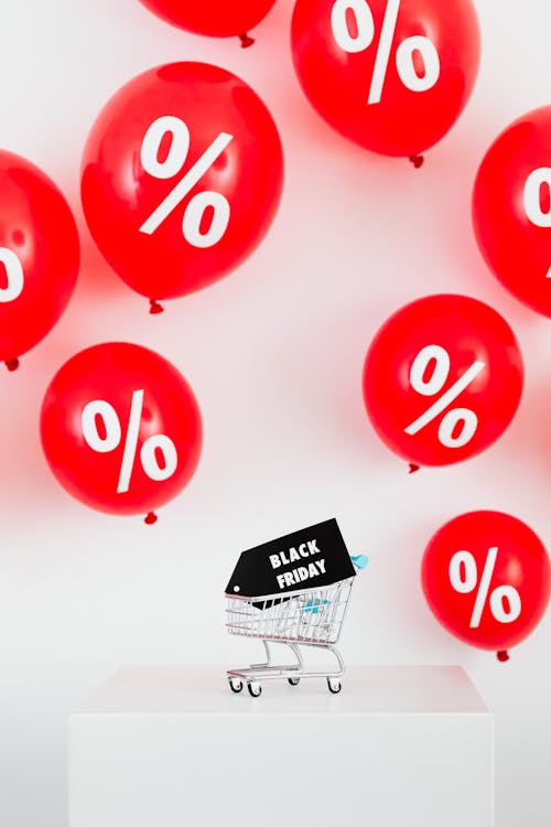 A Black Friday Sale Signage in a Miniature Shopping Cart