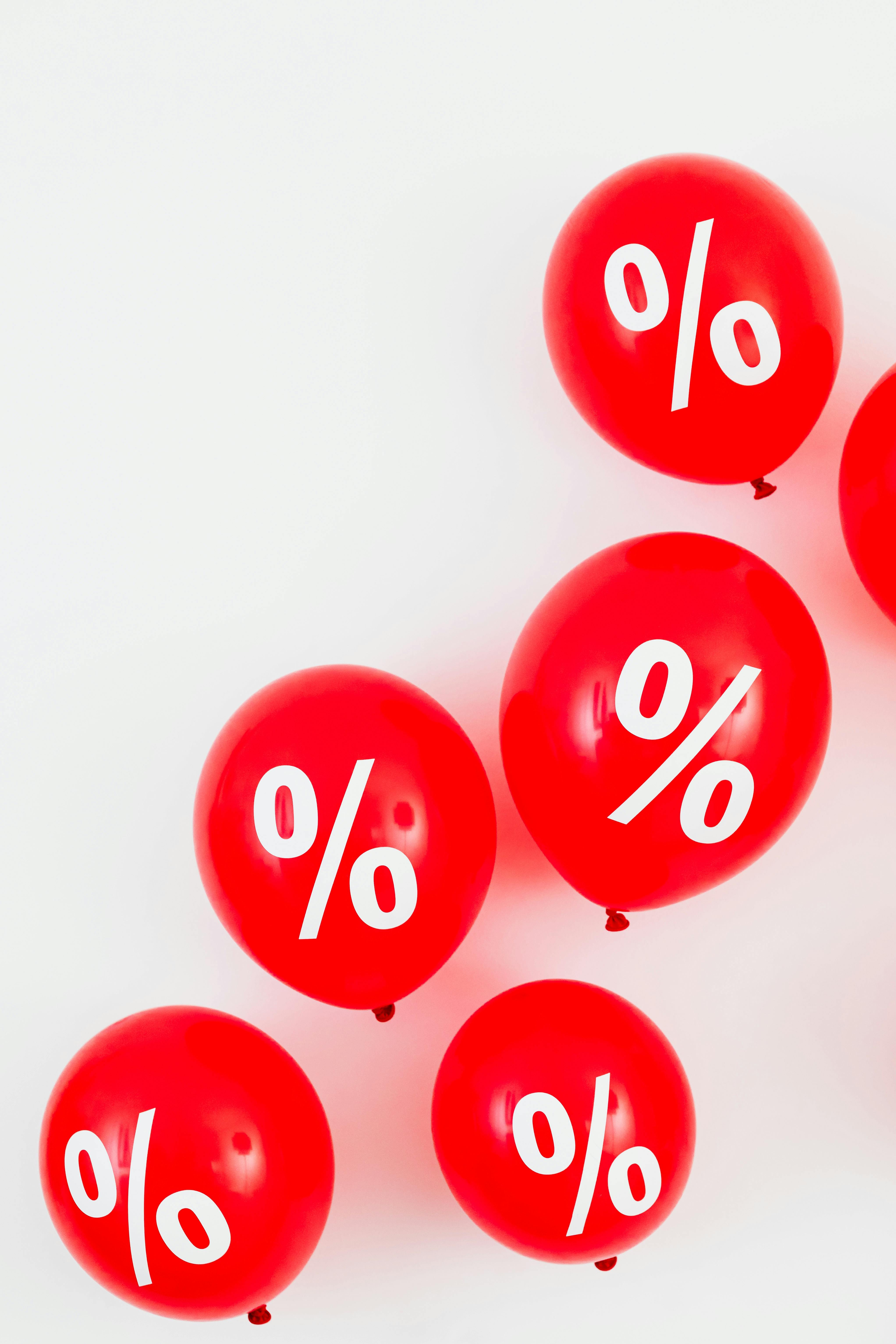 red balloons with percentage symbols on white background