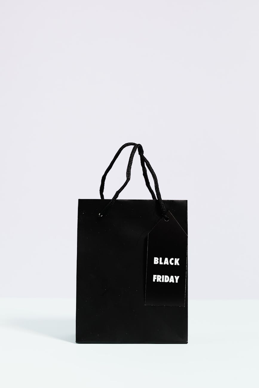 Minimalist black shopping bag with Black Friday tag, perfect for holiday sales themes.