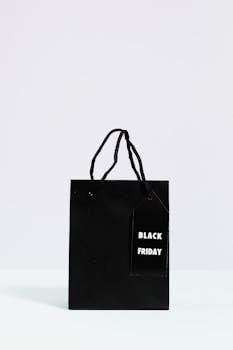 Minimalist black shopping bag with Black Friday tag, perfect for holiday sales themes.