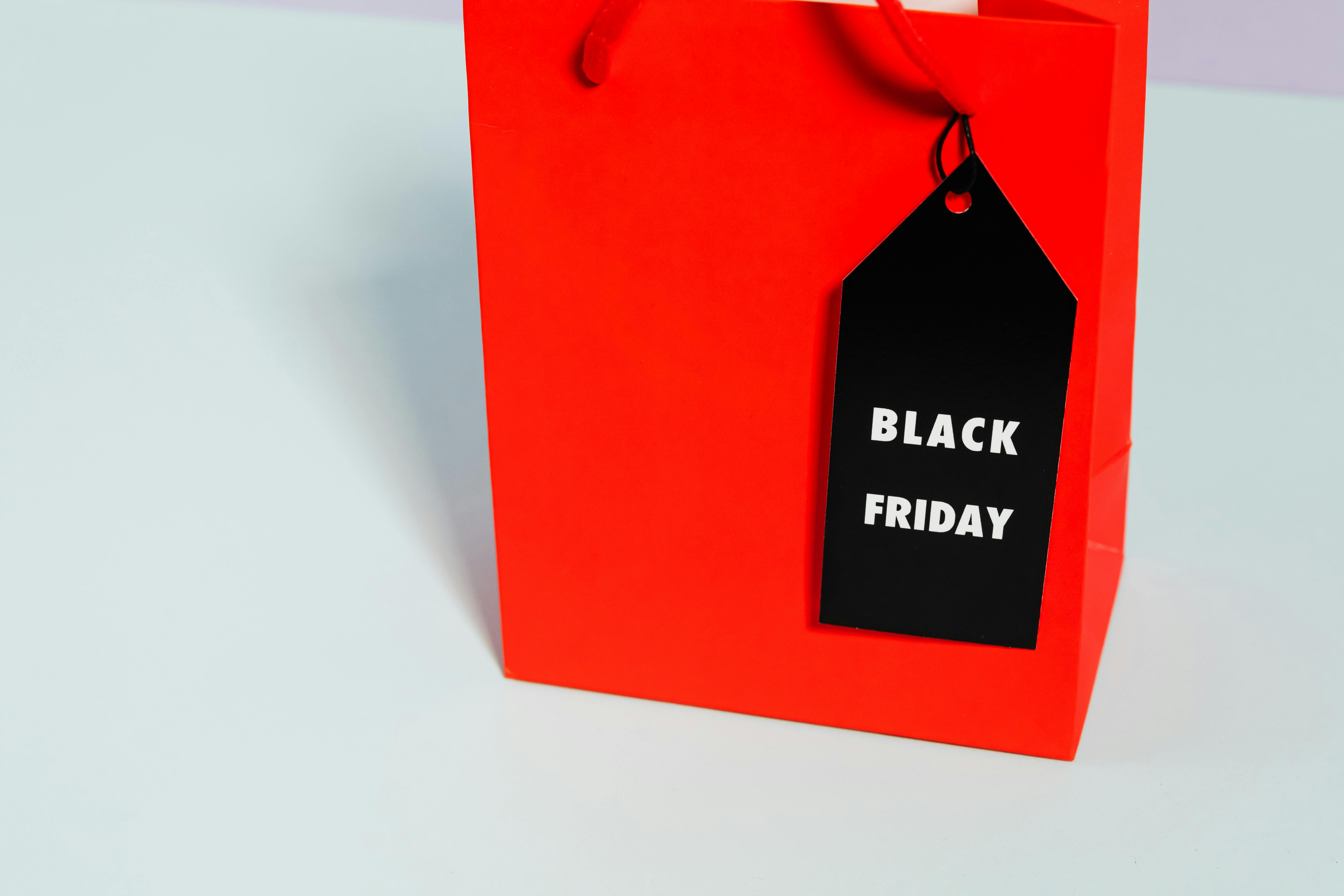 red paper bag with black friday tag