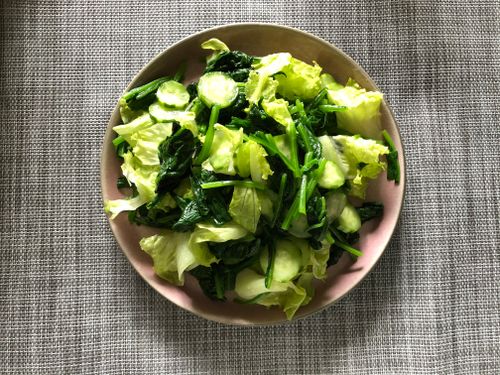 Free A vibrant green salad of spinach, cucumber, and lettuce on a neutral background. Stock Photo