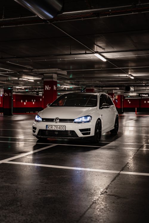 Free Volkswagen parked in a modern, urban underground parking lot in Kraków, Poland. Stock Photo