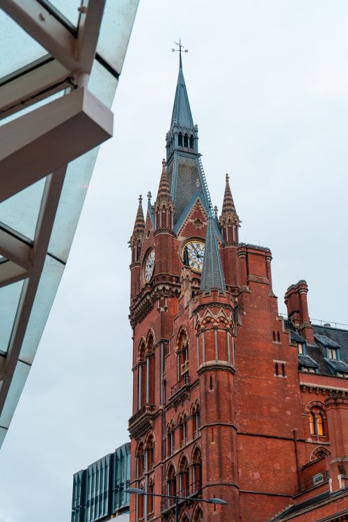 Free Stunning view of the St Pancras Renaissance Hotel's iconic clock tower in London. A must-see architectural landmark. Stock Photo