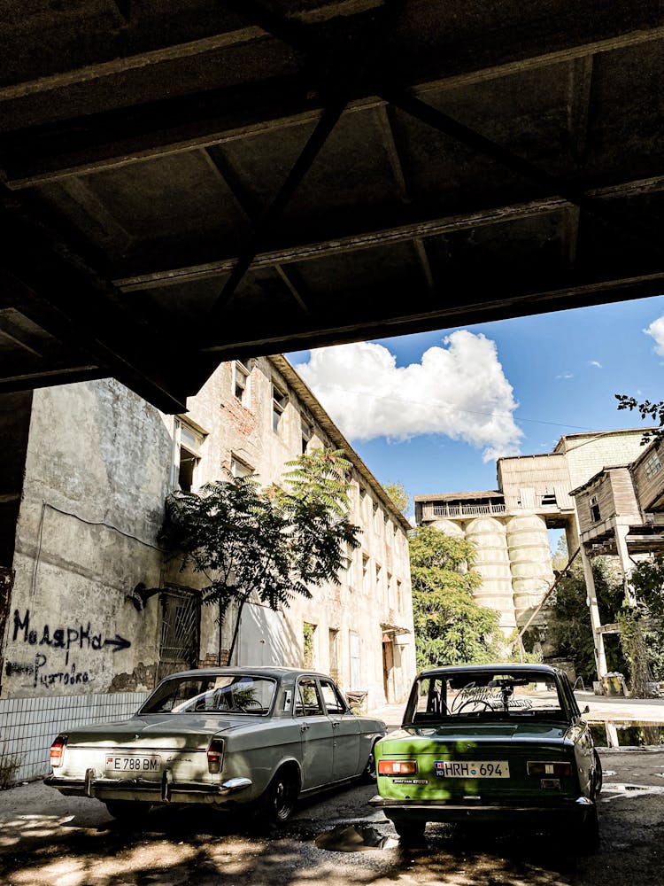 Old Volga And Lada On A City Street 