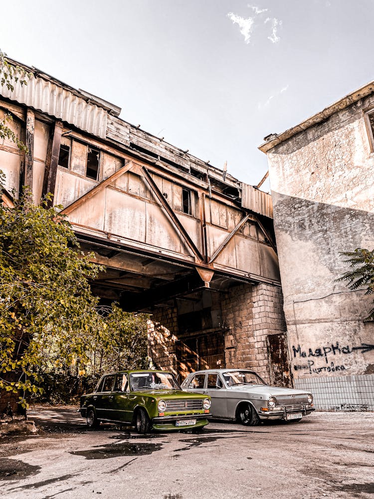 Old Volga And Lada on A City Street