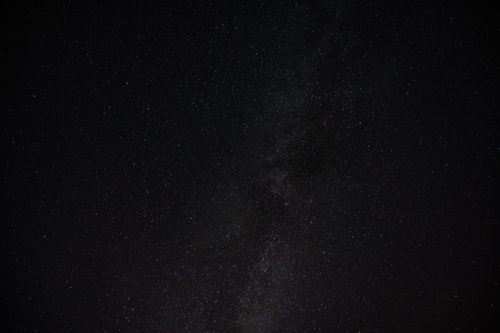 Free A mesmerizing view of a dark starry night sky filled with twinkling stars. Stock Photo