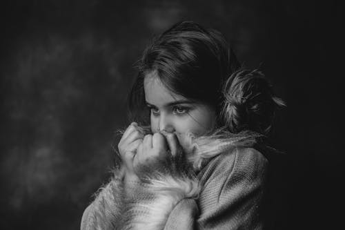 Embracing Fearlessness | The quality of being fearless | Unlocking the Qualities of a Fulfilling Life Free Black and white of contemplative kid in stylish outfit covering face while looking away Embracing Fearlessness