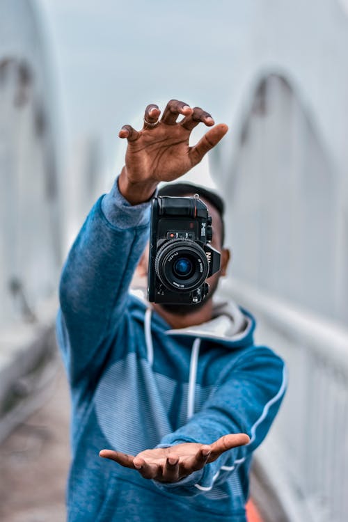 Photo of a Camera Near a Man's Hands